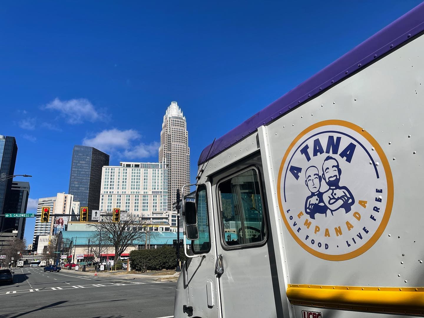 A Tana Empanada truck with Charlotte skyline